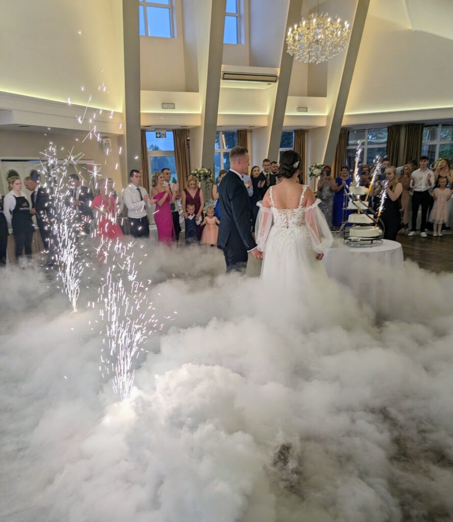Eleganckie nakrycie stołu weselnego a w tle saksofonistka na żywo, symbolizująca współpracę muzyki z kuchnią.